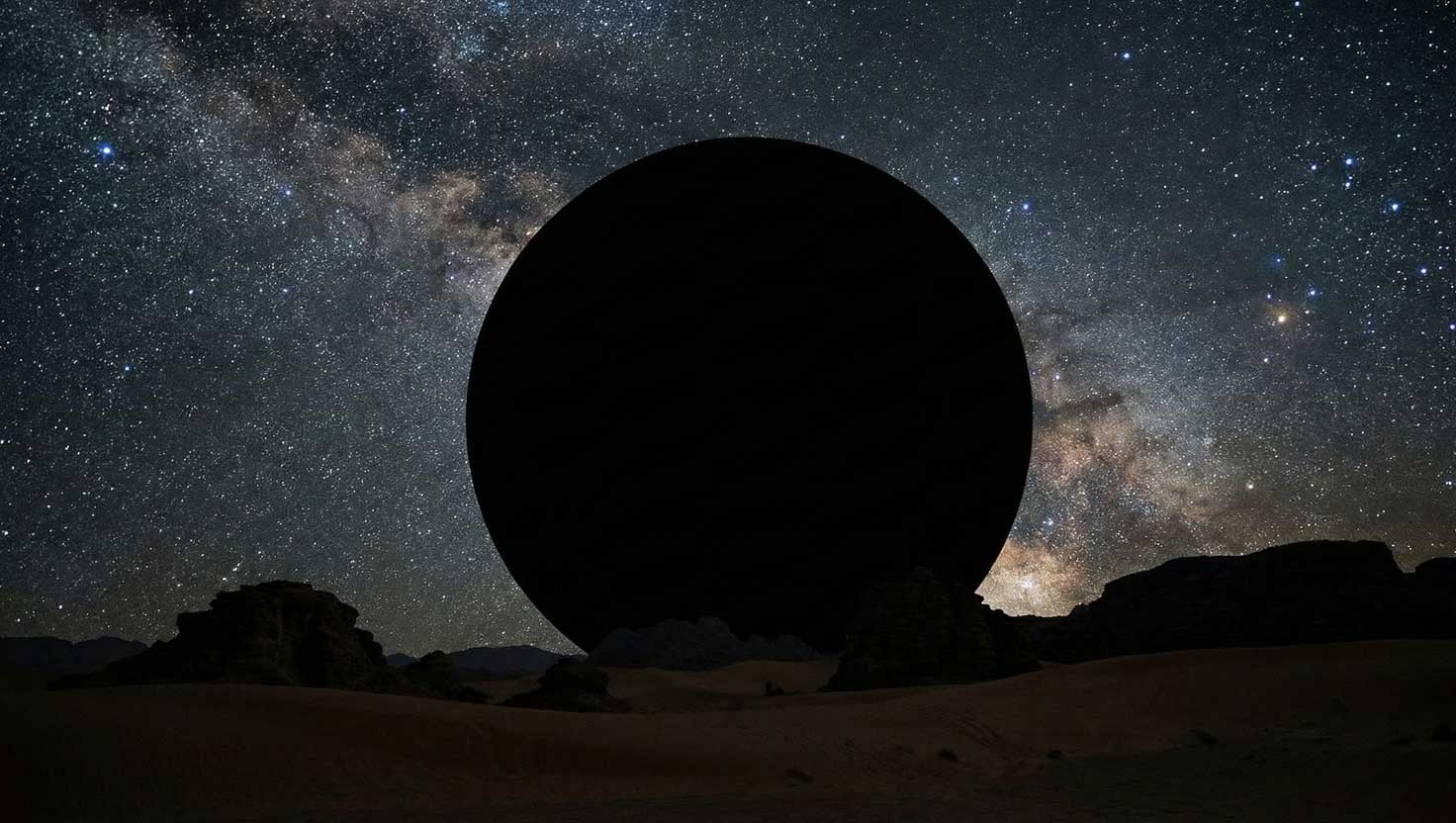 A desert night sky with a clean circular patch of missing stars, creating the appearance of an invisible object blocking the heavens.